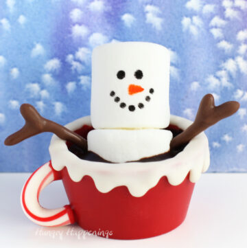 Snowman Hot Chocolate Bomb - white chocolate mug with a candy cane handle filled with chocolate ganache and a marshmallow snowman