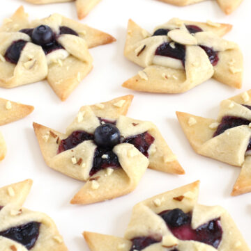 Windmill cookies filled with sweetened cream cheese and blueberry preserves.