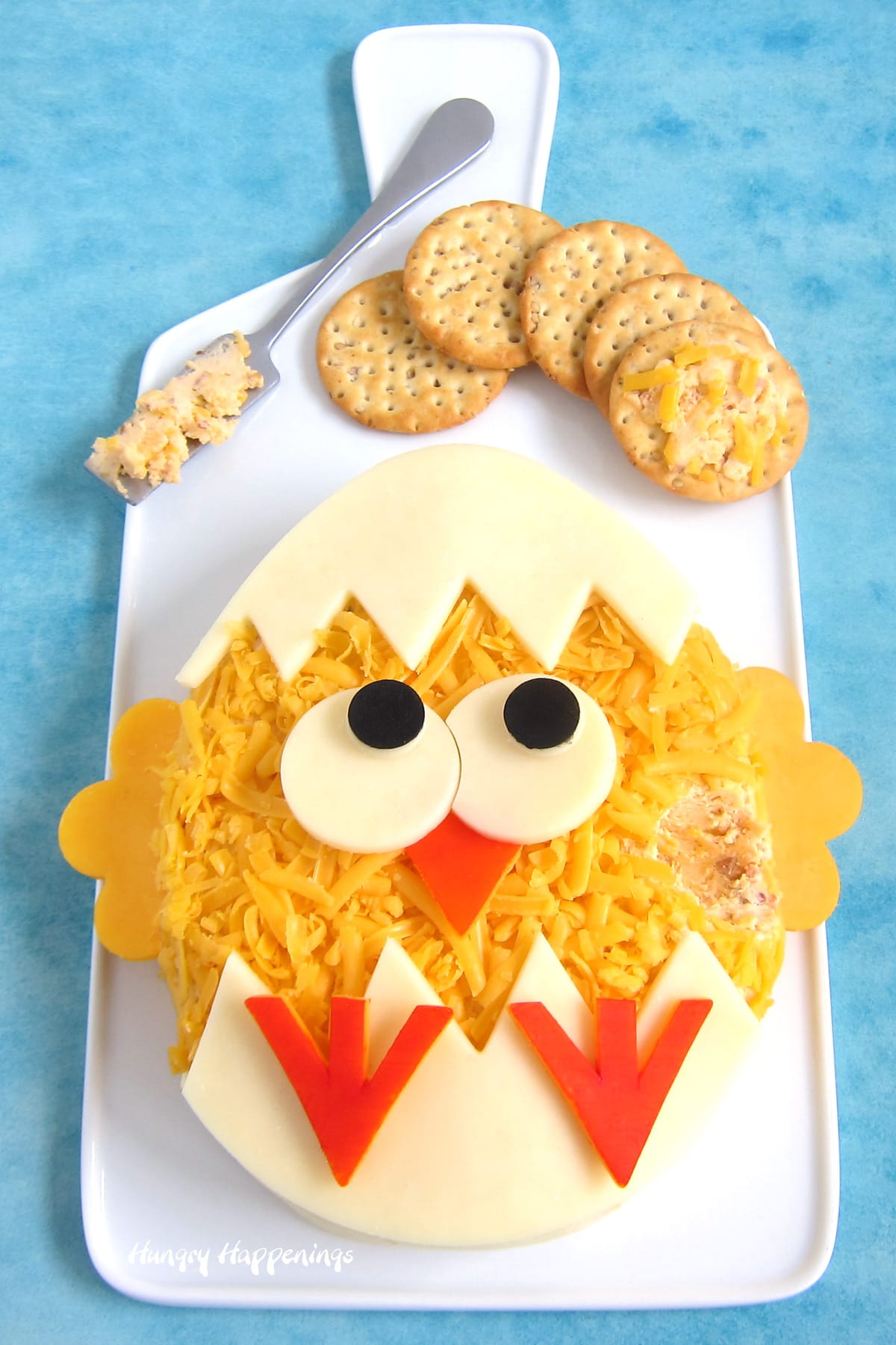 Hatching chick cheese ball for Easter served with crackers.