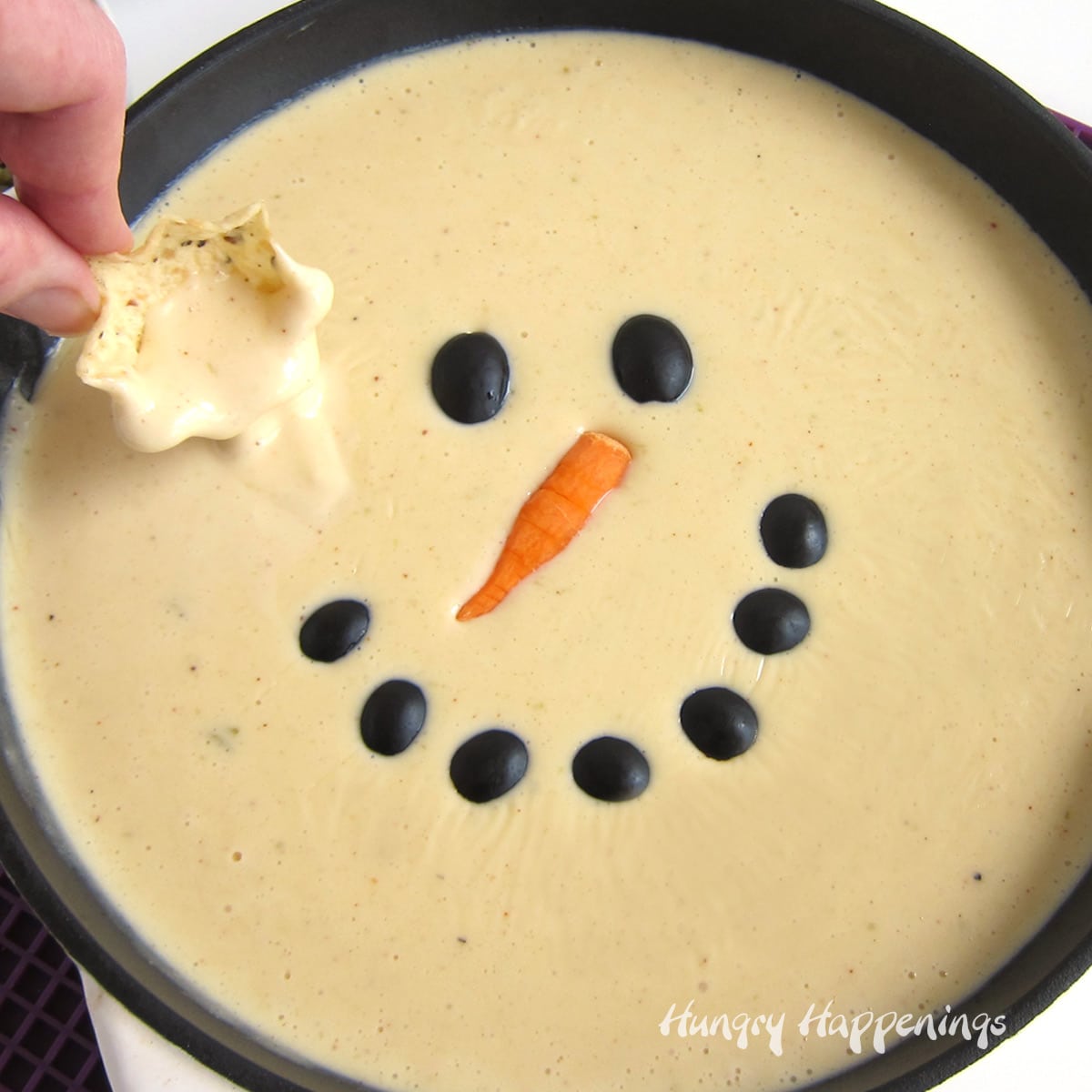 Christmas queso dip snowman with tortilla chip