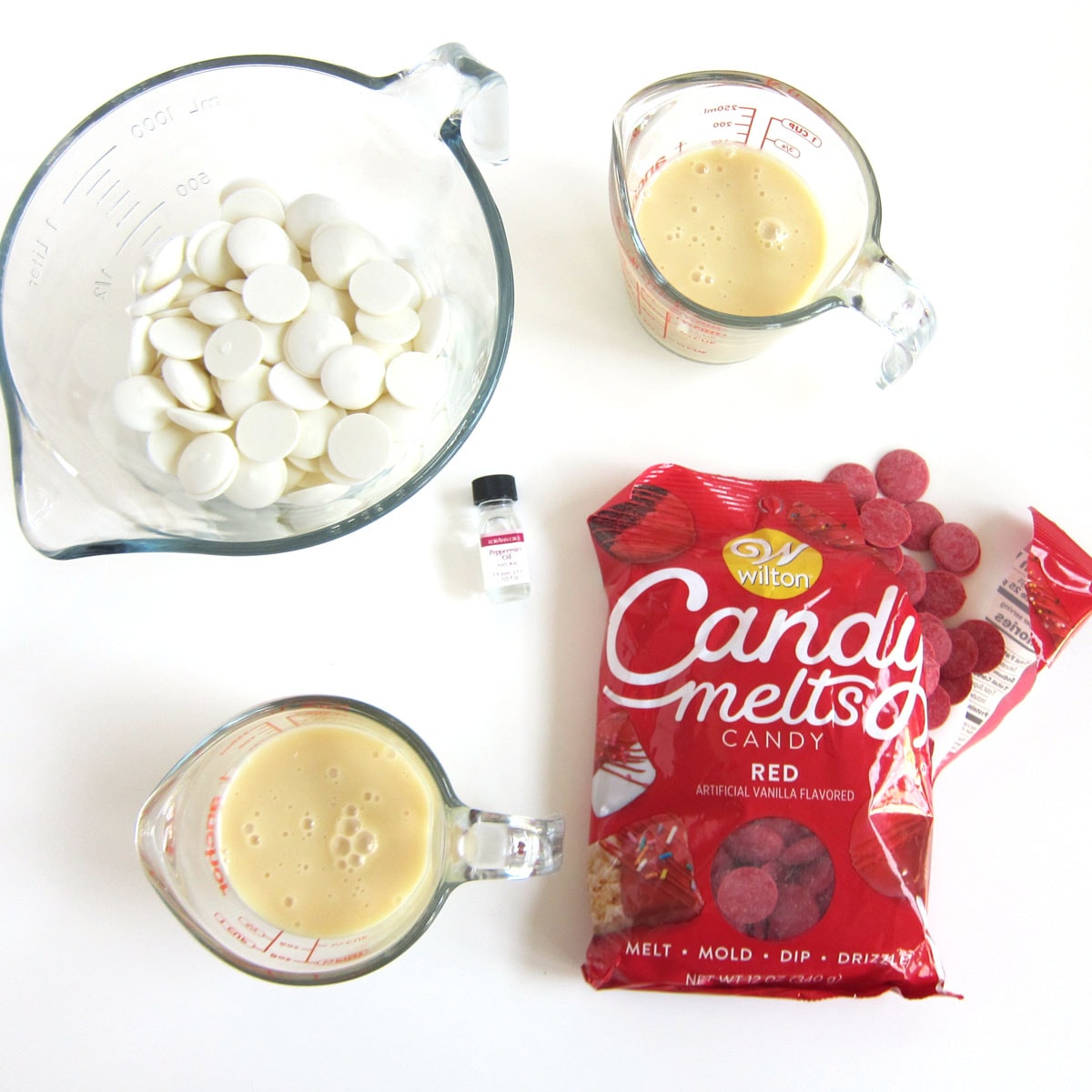 red and white candy melts with sweetened condensed milk and peppermint oil