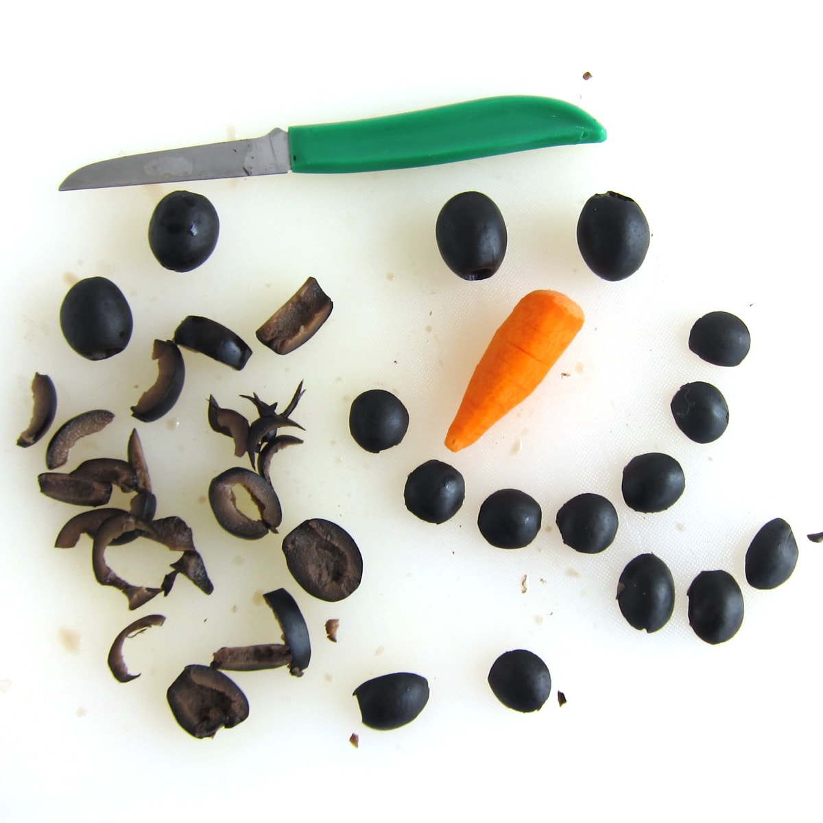 Cut black olive eyes and smile and a carrot nose for the snowman dip.