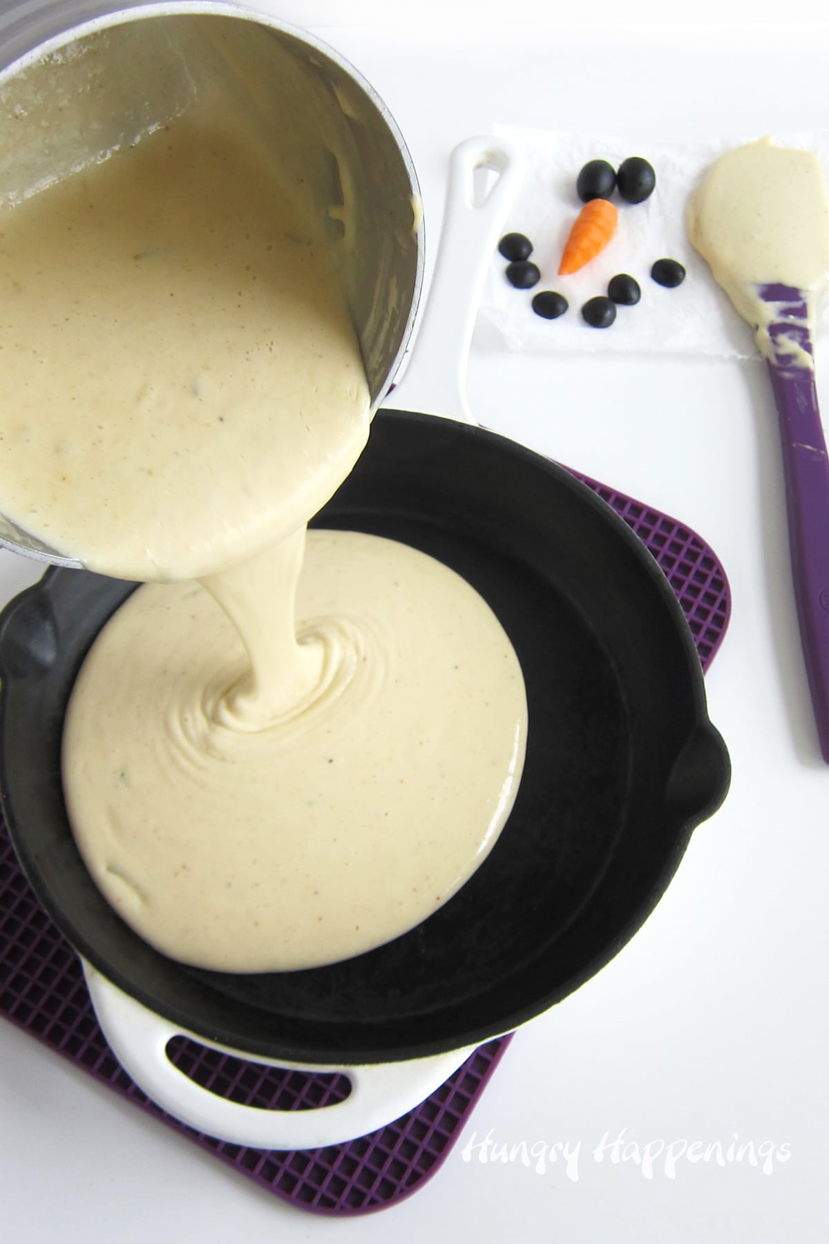 pour white queso dip into a hot skillet