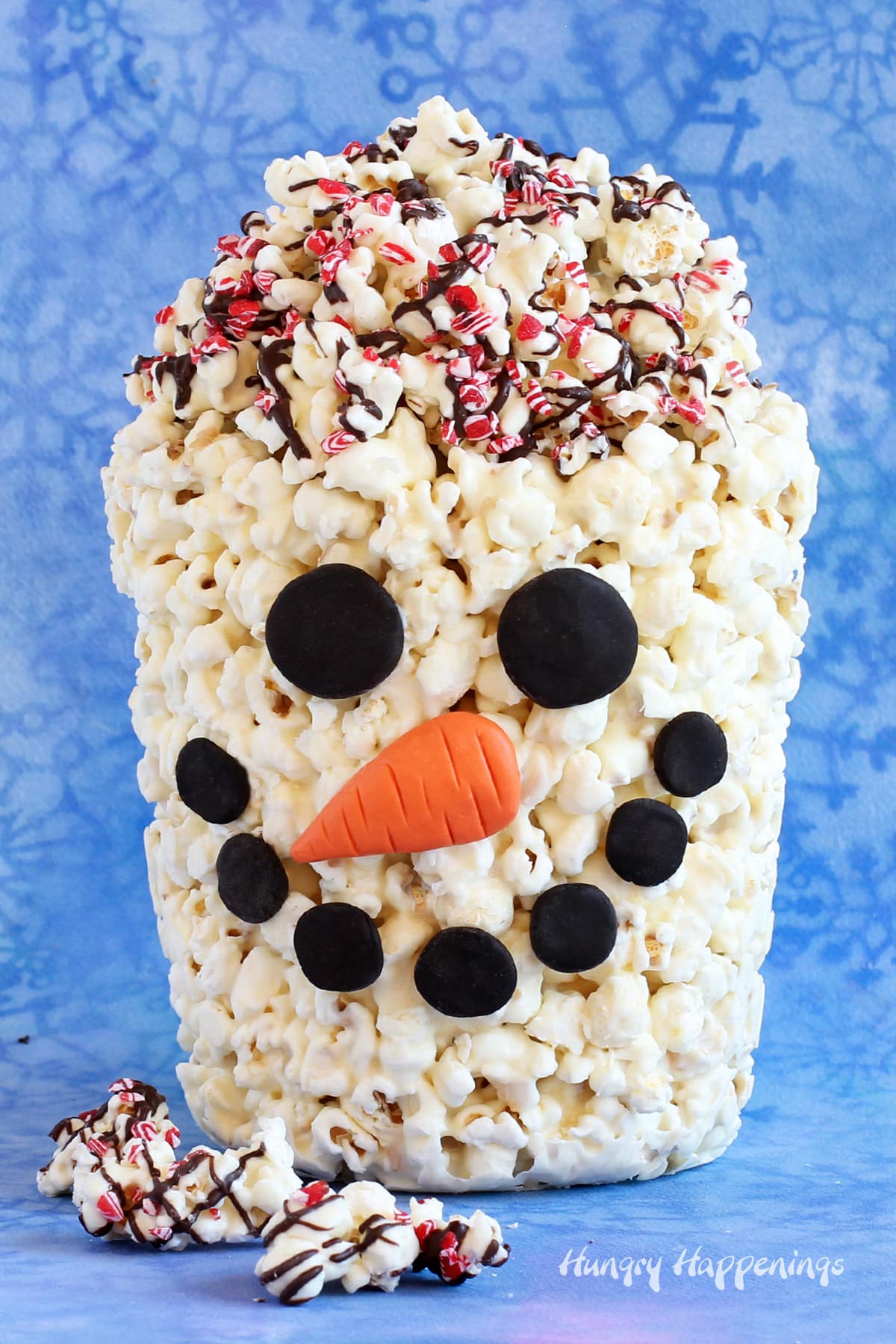 Snowman popcorn bucket filled with white chocolate peppermint popcorn.