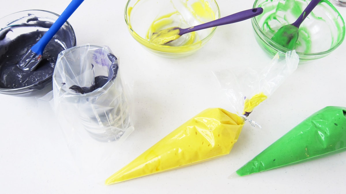 fill pastry bags with yellow, green, and purple cake batter
