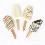 Cakesicles with red and green drizzle, rainbow sprinkles, and chocolate drizzle