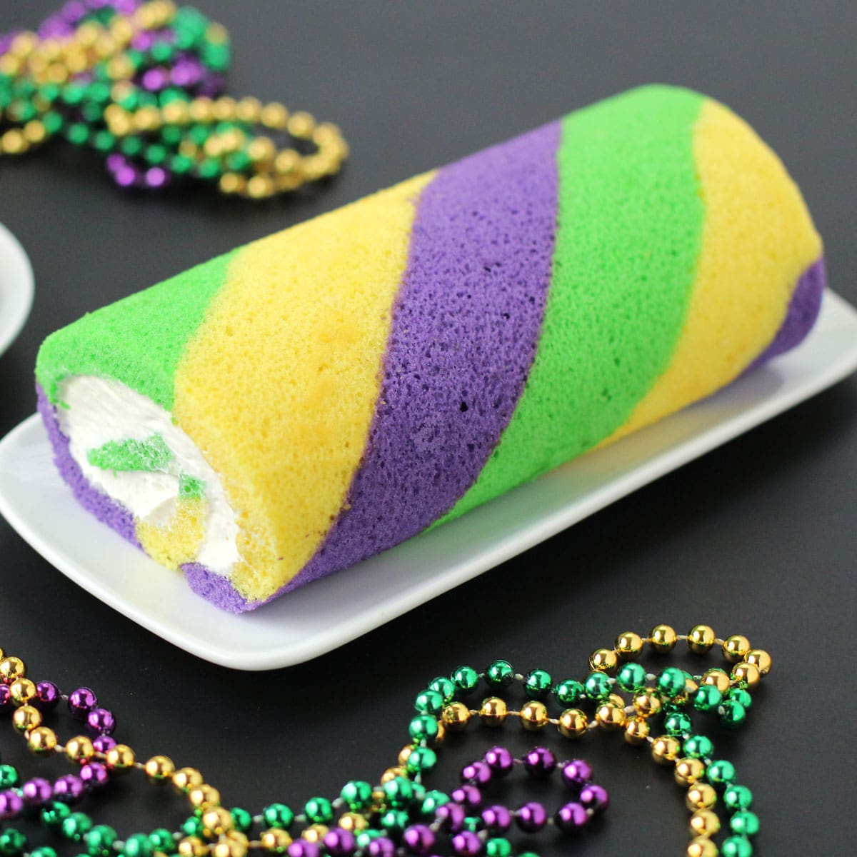 Mardi Gras Cake Roll with green, yellow, and purple stripes