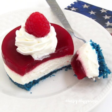 Red, white, and blue no-bake cheesecake with blue cookie crust and raspberry gelee on top