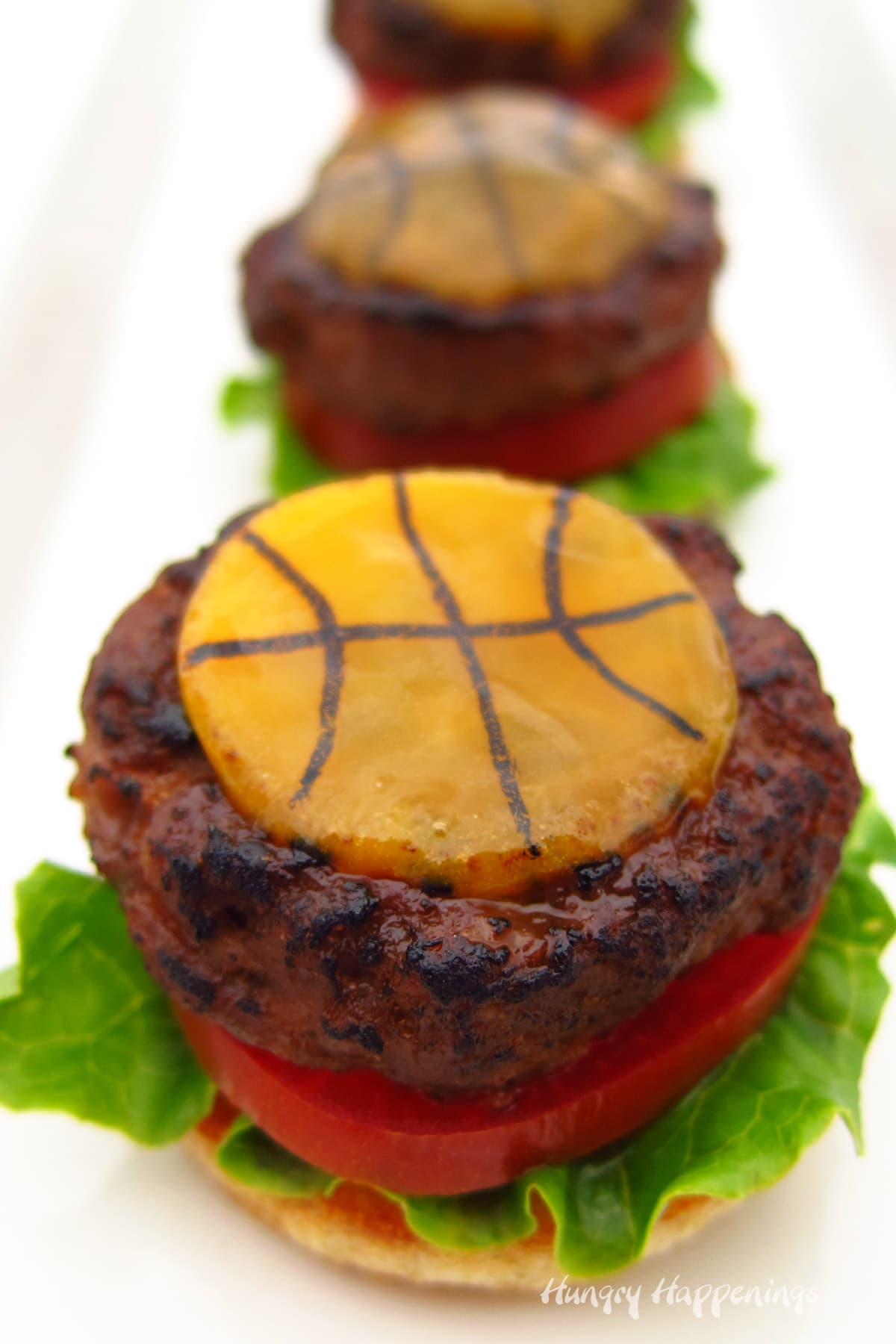 basketball cheese-topped sliders with lettuce and tomato
