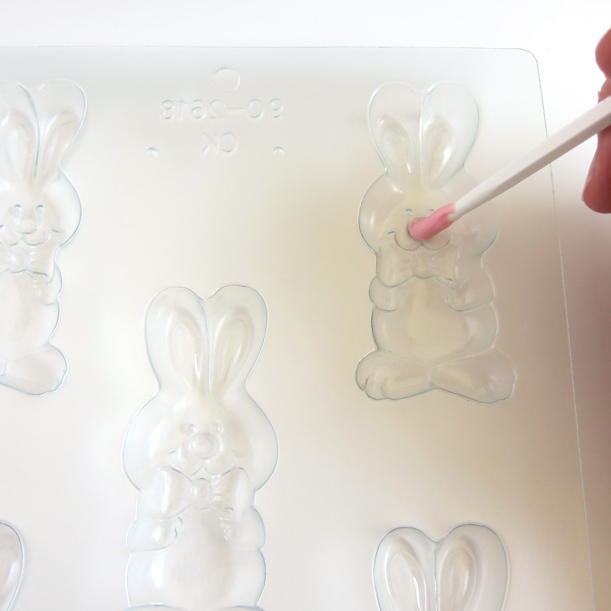 painting a pink nose in a bunny candy mold