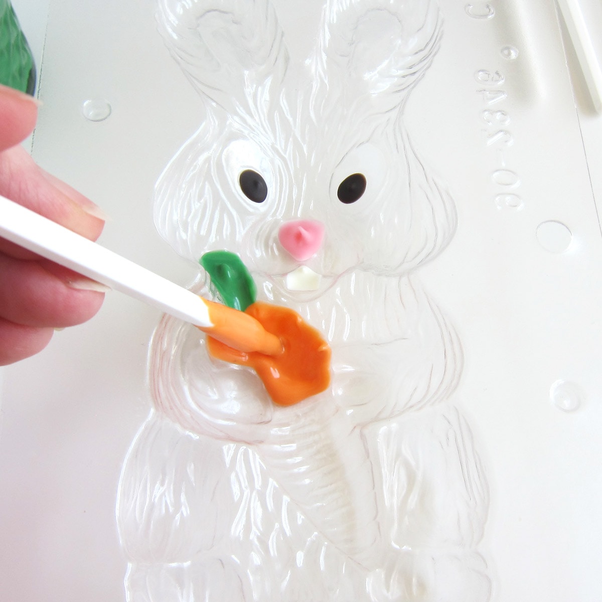 Painting orange candy melts into the bunny with carrot candy mold.