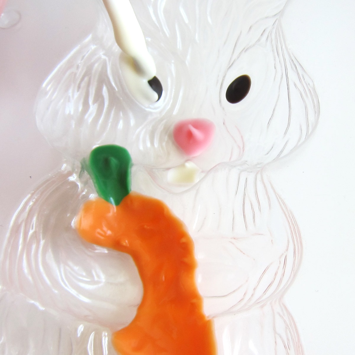 Painting the whites of the bunny's eye in the bunny candy mold.