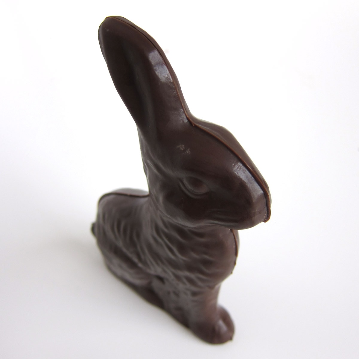 solid chocolate bunny standing on white table