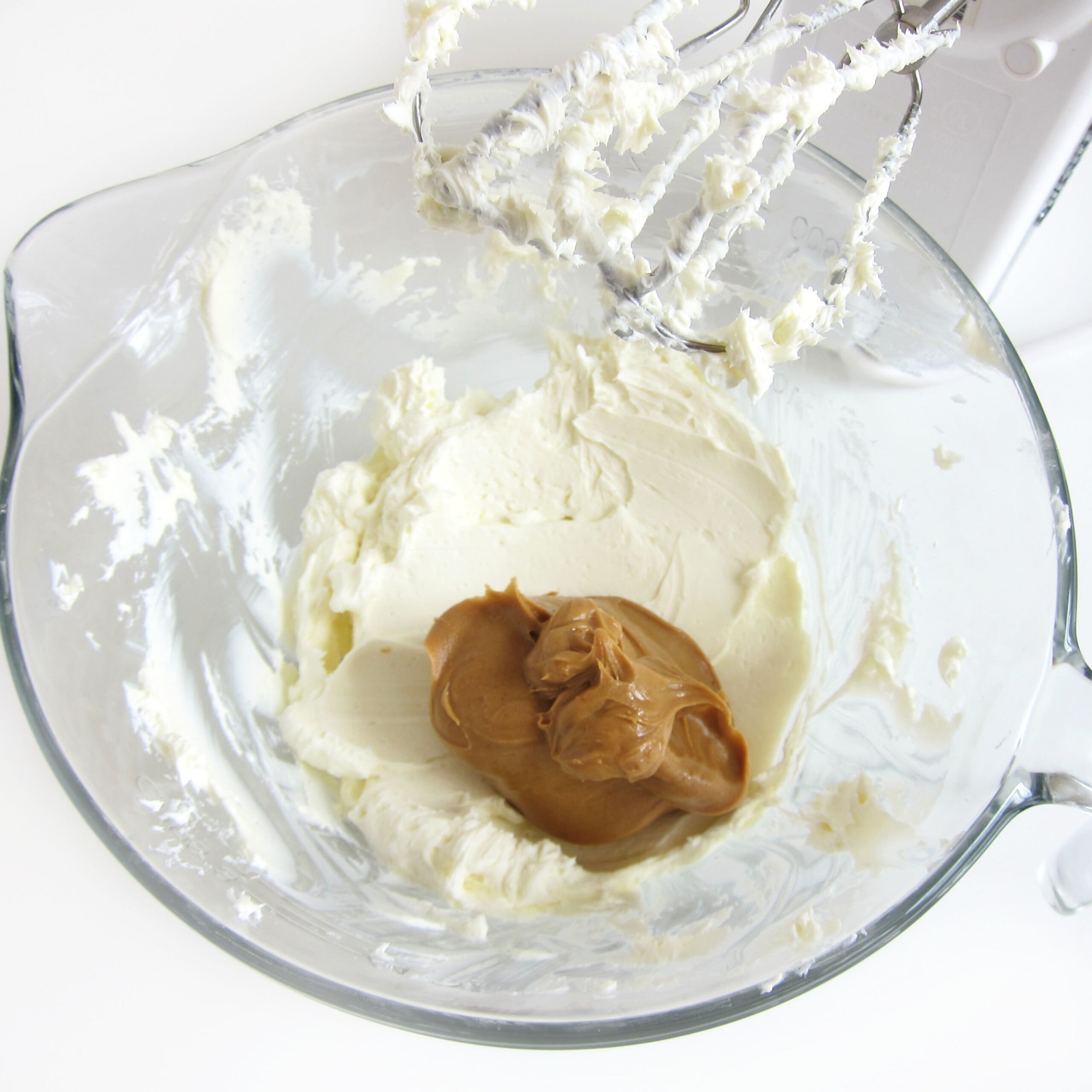Creamy peanut butter and whipped cream cheese in a mixing bowl.