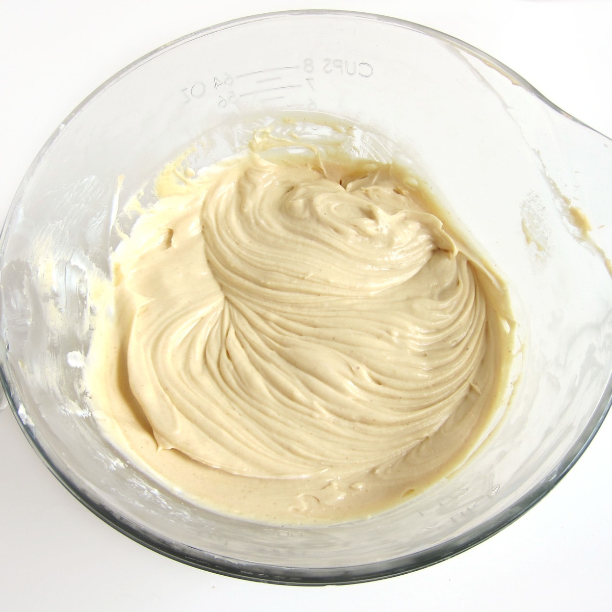 Peanut butter cheesecake filling in a mixing bowl.