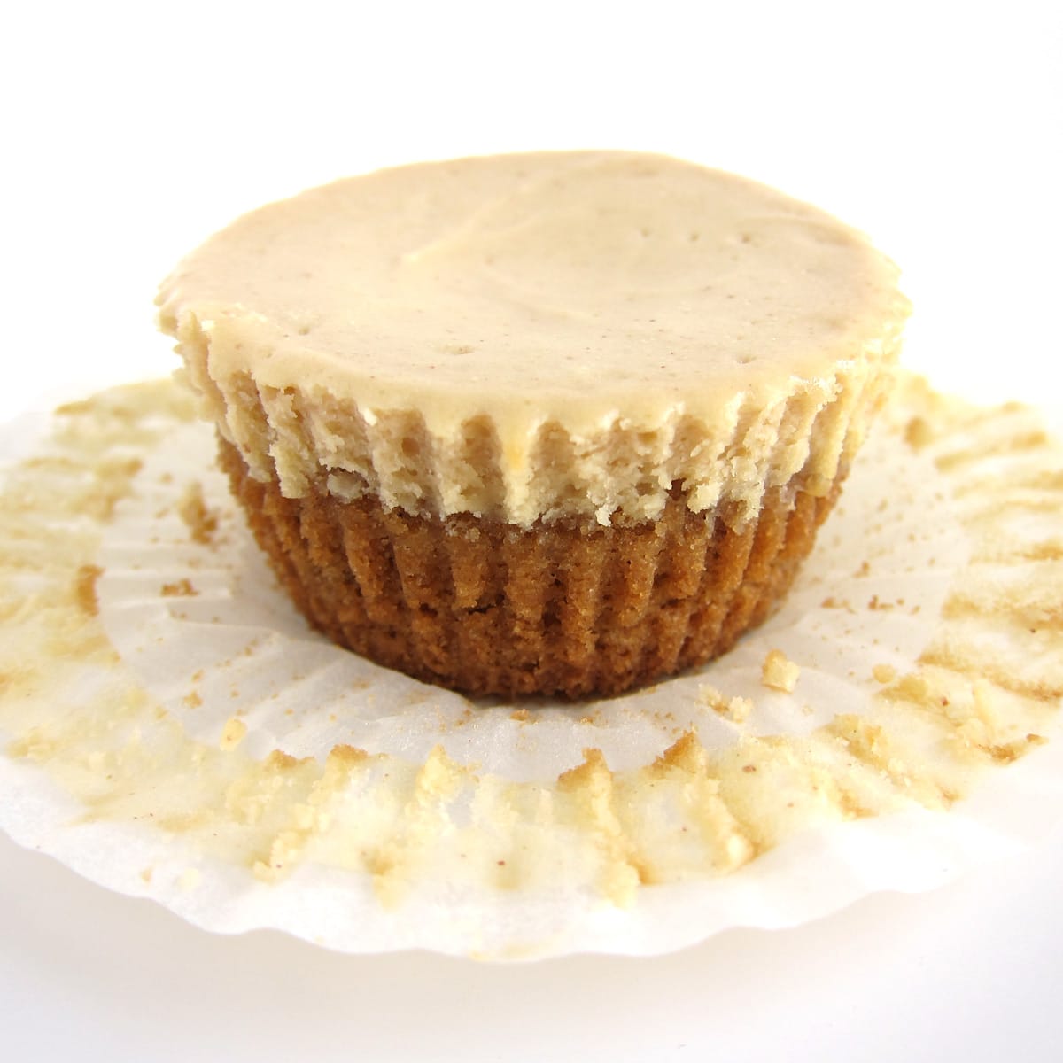Mini peanut butter cheesecake with paper cupcake wrapper removed.