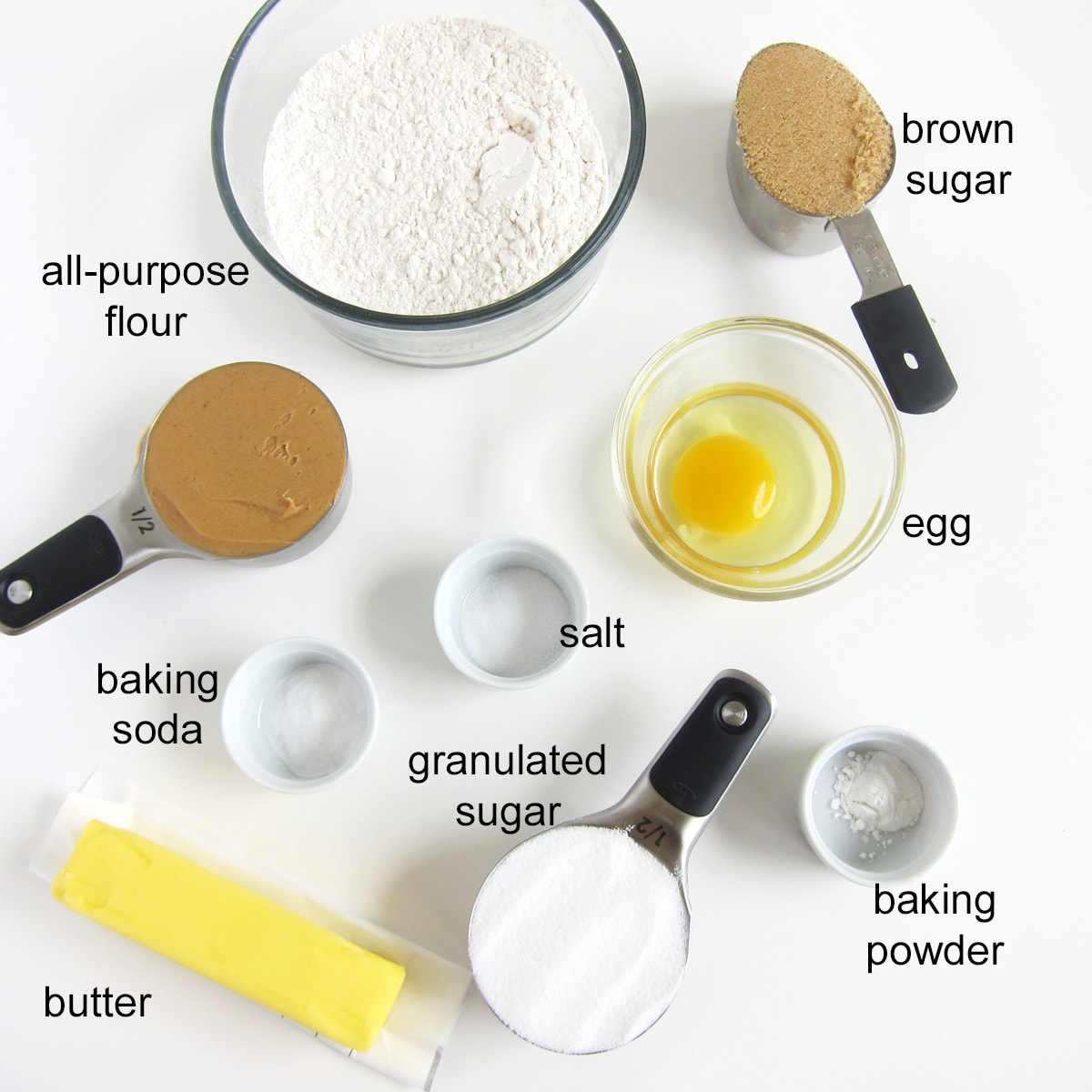 Peanut butter cookie ingredients including brown sugar, granulated sugar, butter, peanut butter, egg, flour, baking soda, baking powder, and salt.