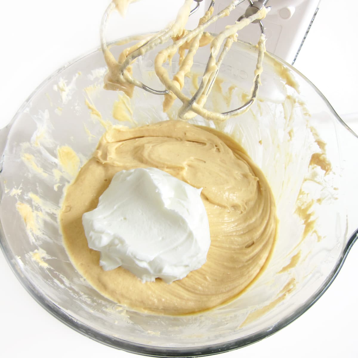 sour cream in bowl of peanut butter cheesecake filling