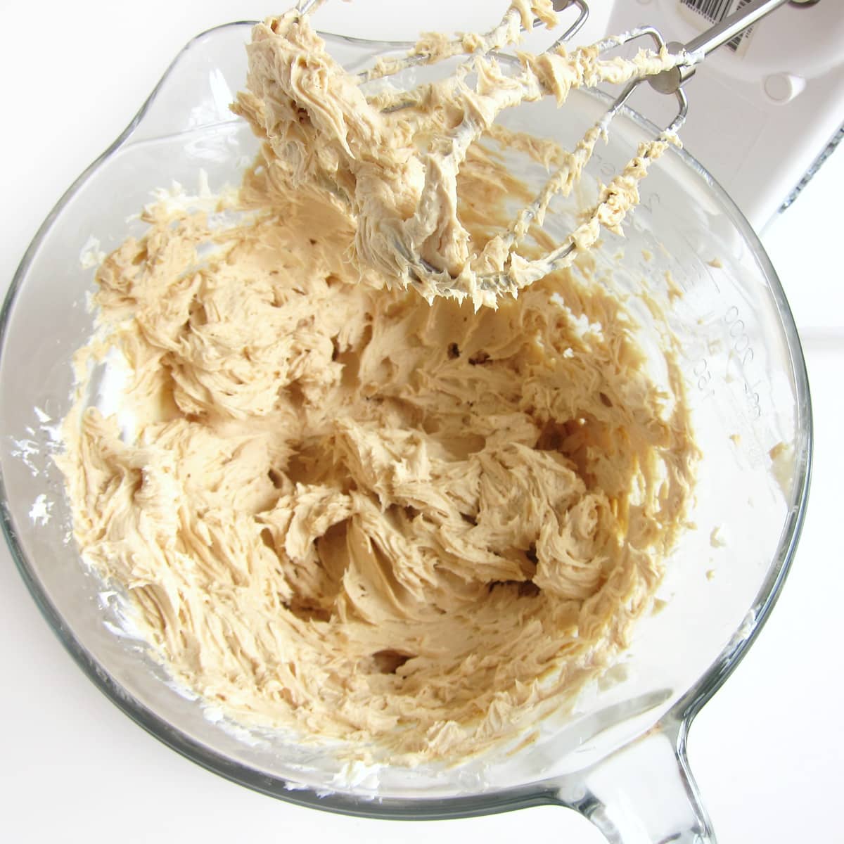 peanut butter and cream cheese whipped together in a mixing bowl.