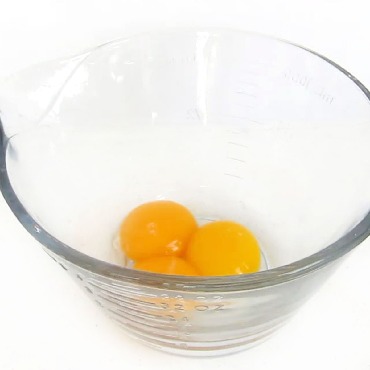 3 egg yolks in a mixing bowl