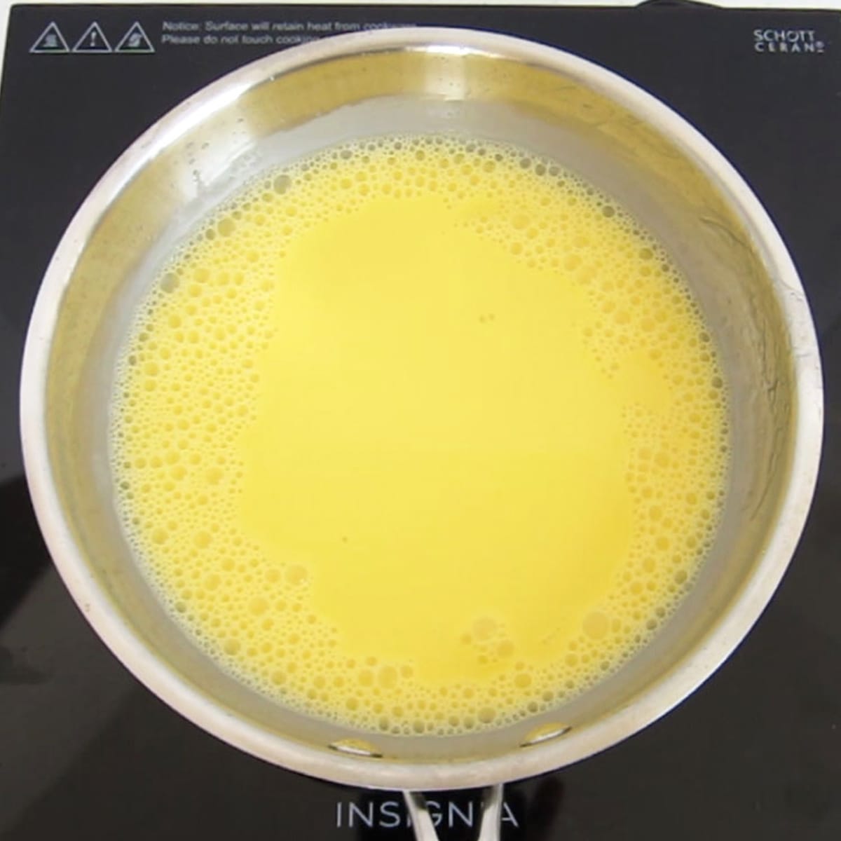 custard cooking in a stainless steel skillet