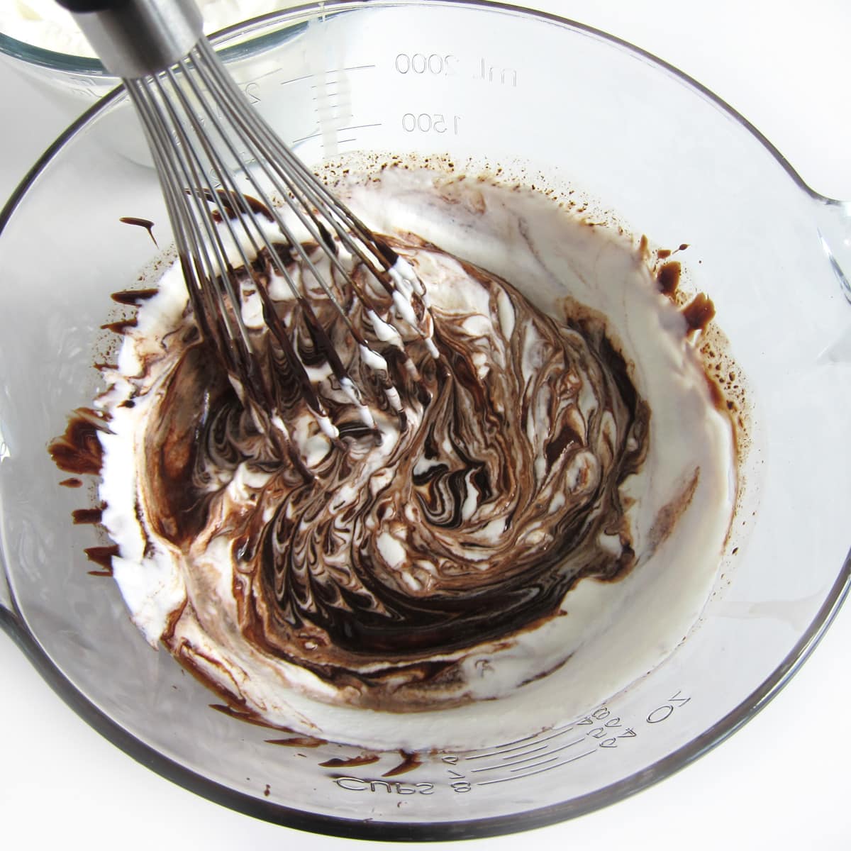 whisking whipped cream and chocolate together