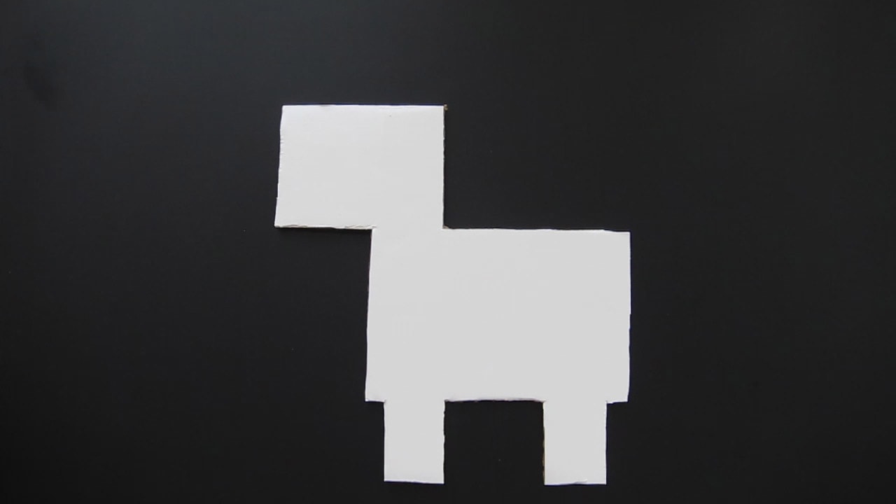 cardboard cake board cut into a simple unicorn shape.