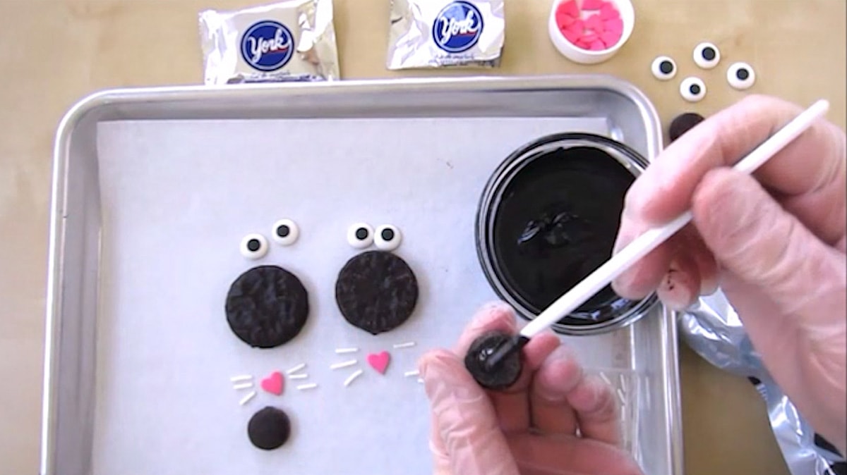 brushing melt black candy melts onto the back of a mini Peppermint Patty.