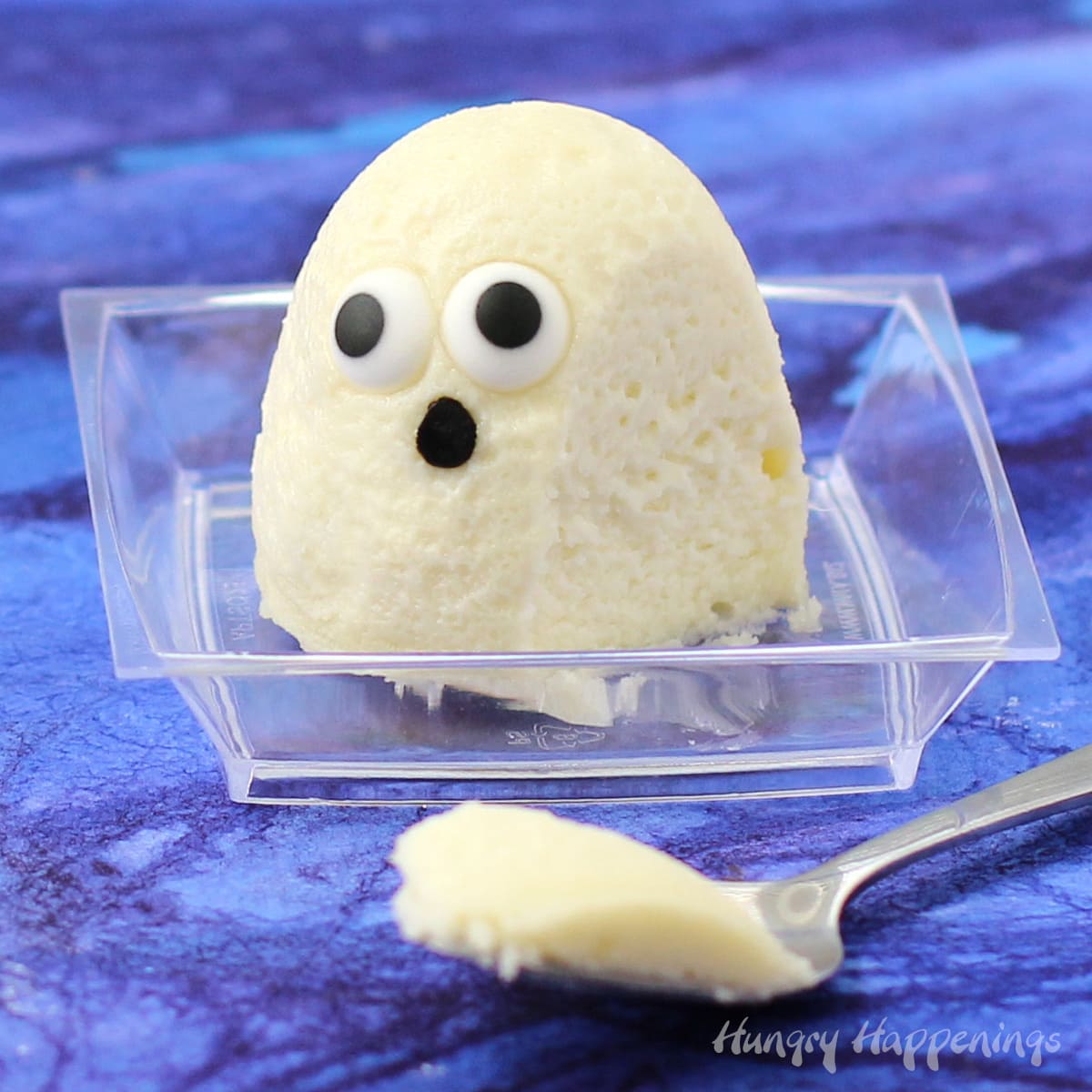 mini ghost cheesecake with a spoonful of cheesecake