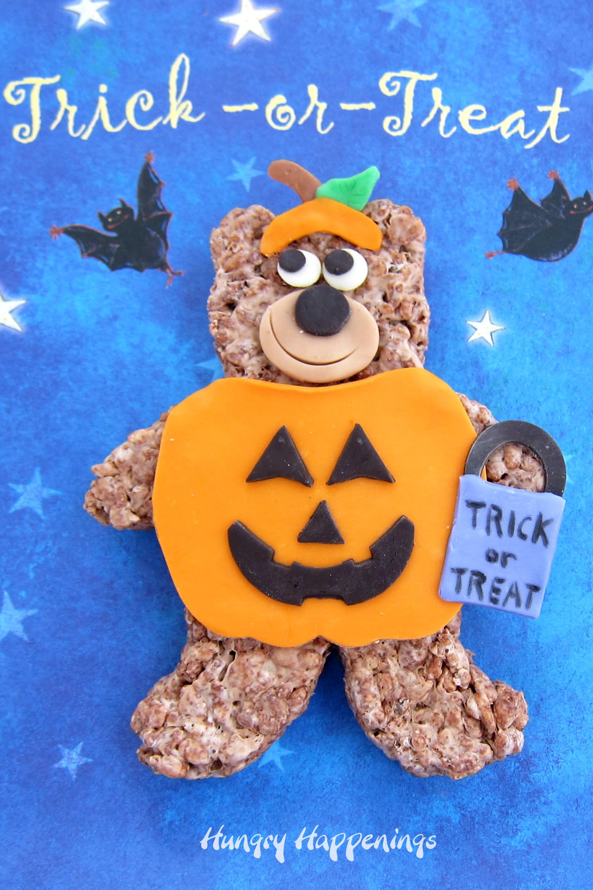 Halloween rice krispie treats bear in a pumpkin costume made out of modeling chocolate.
