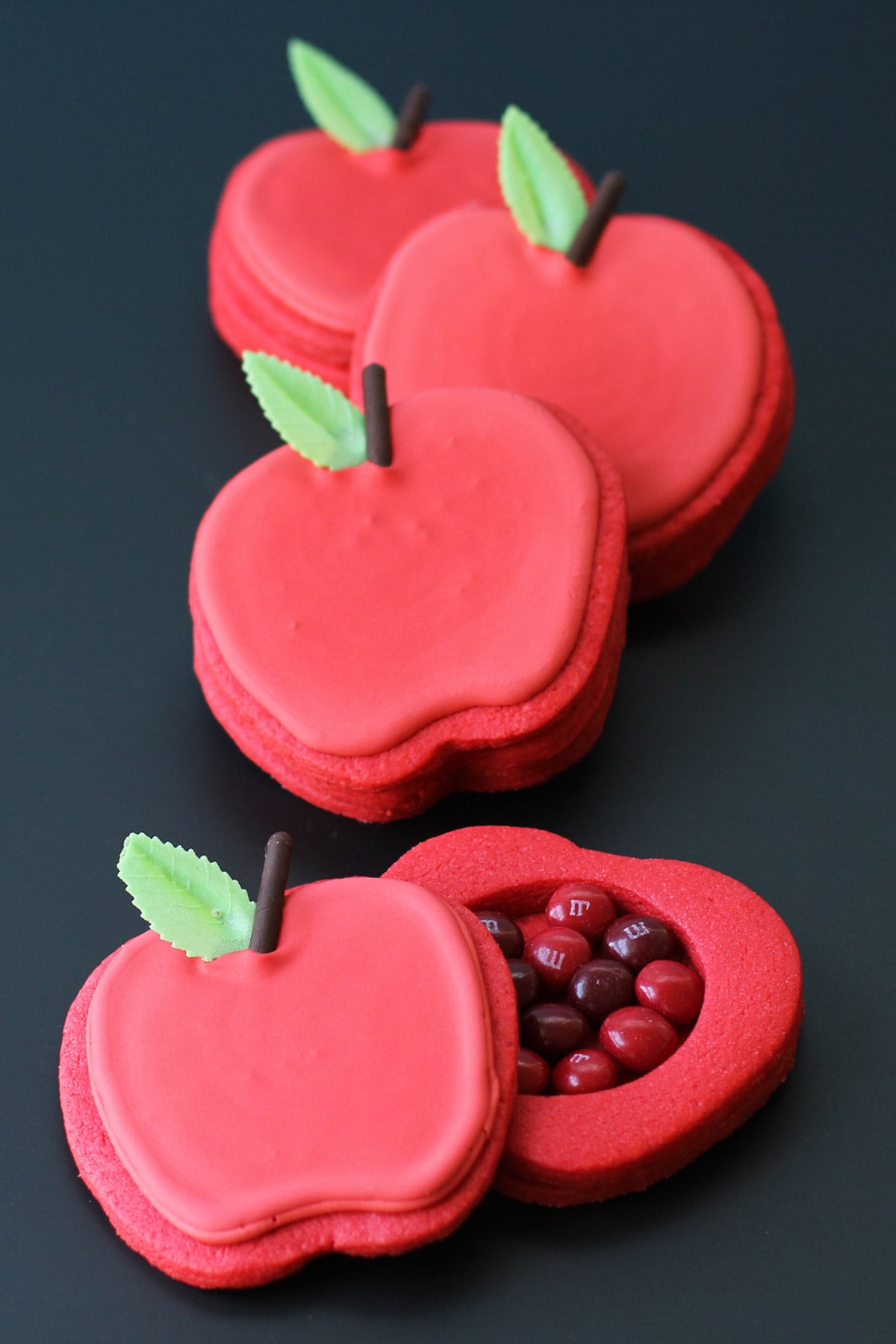 candy-filled apple cookies on a black background