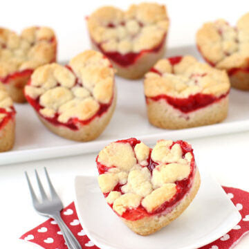 2-ingredient heart-shaped cherry pie bars served on white plates with a red and white Valentine's Day napkin.