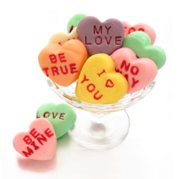conversation heart fudge in a glass candy dish.