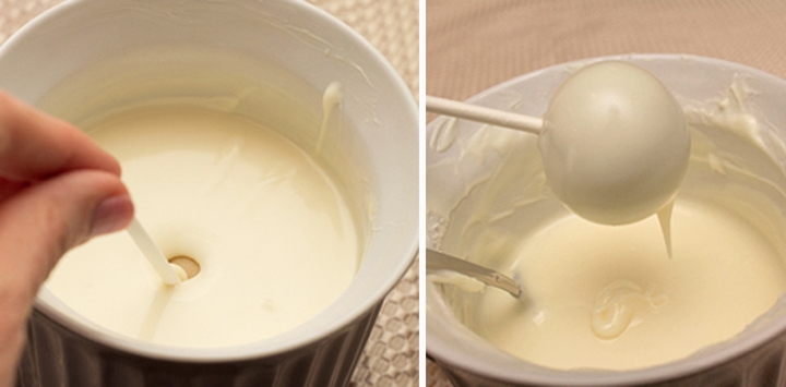 dipping a cake ball into white candy melts then remove it and allow the excess chocolate to drip off.