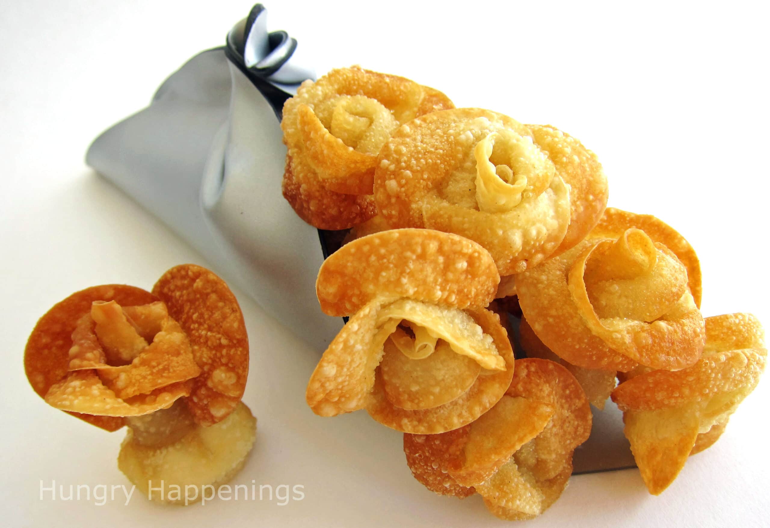 a bouquet of fried won ton roses in a silver cornet.