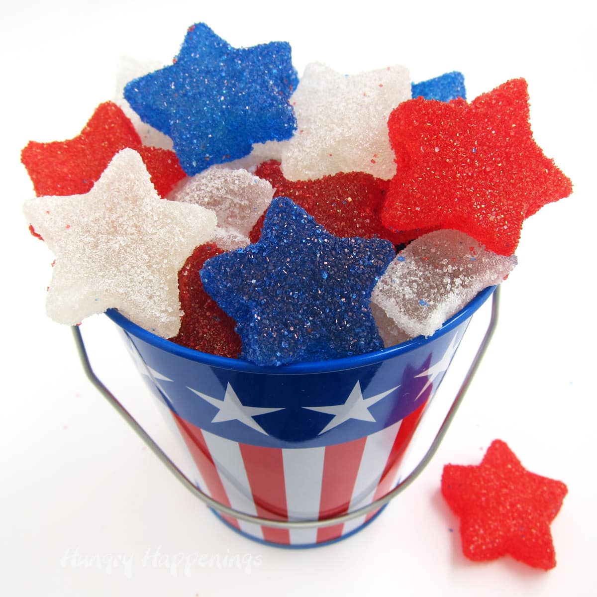 homemade gumdrops red, white, and blue stars in a metal pail with stars and stripes.