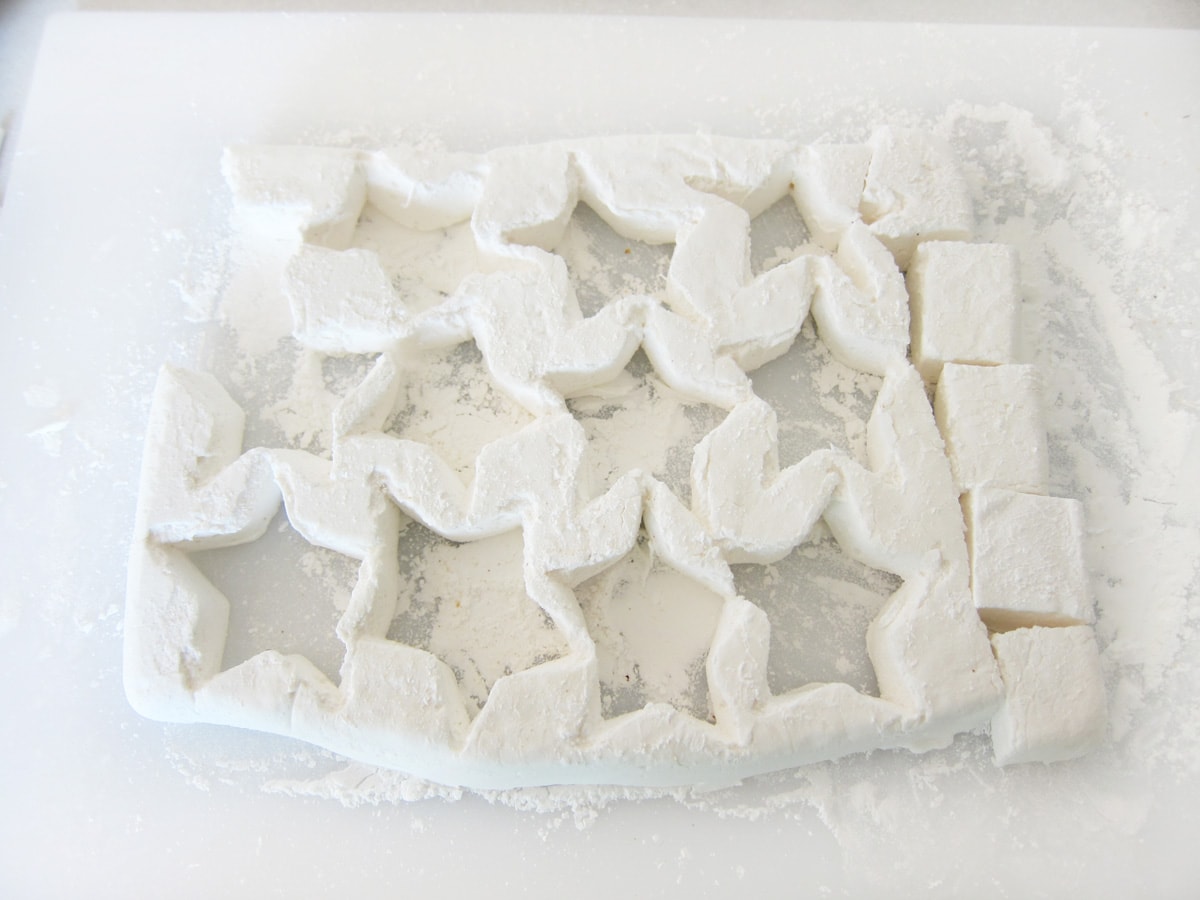 sheet of marshmallows with 12 stars cut out.