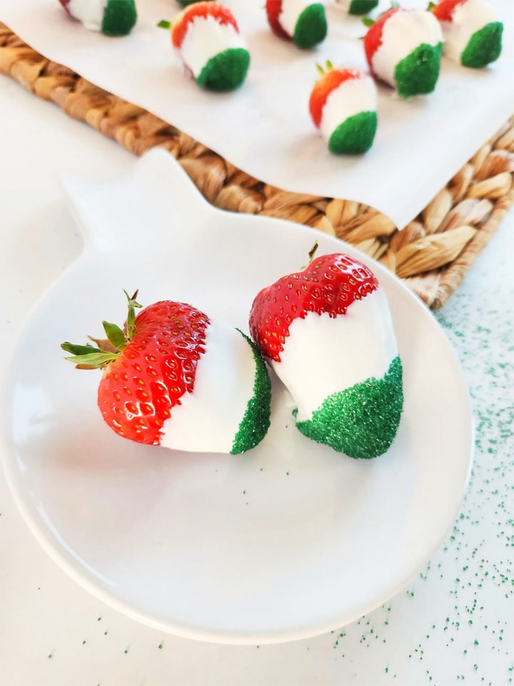 white chocolate dipped strawberries decorated with green sugar to look like the Mexican flag.