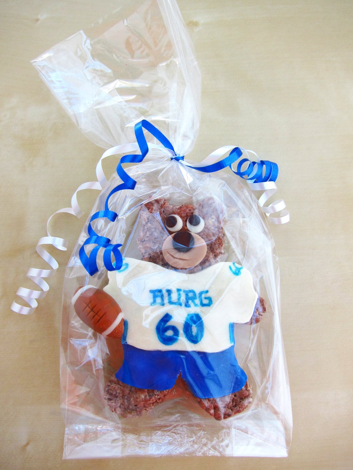 Rice Krispie Treat bear in a blue and white modeling chocolate football uniform.