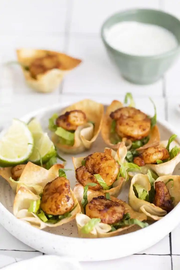 zesty shrimp taco cups in baked won ton cups with lime zest and crema.