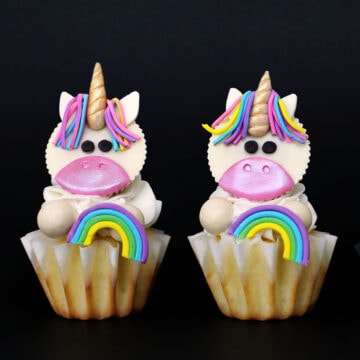 cute Unicorn Cupcakes with White Reese's Cup unicorns holding a rainbow.