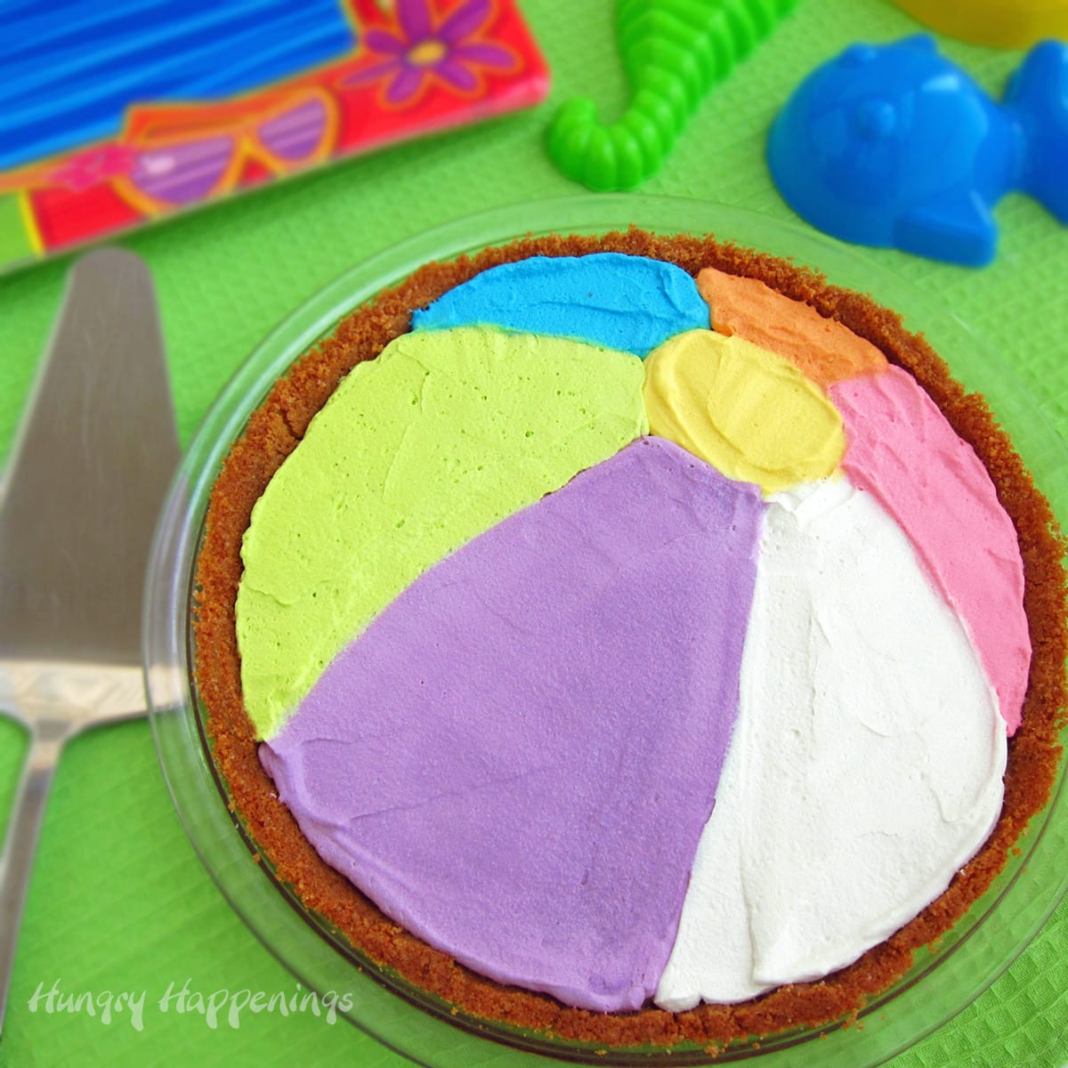beach ball pie decorated with colored whipped cream.