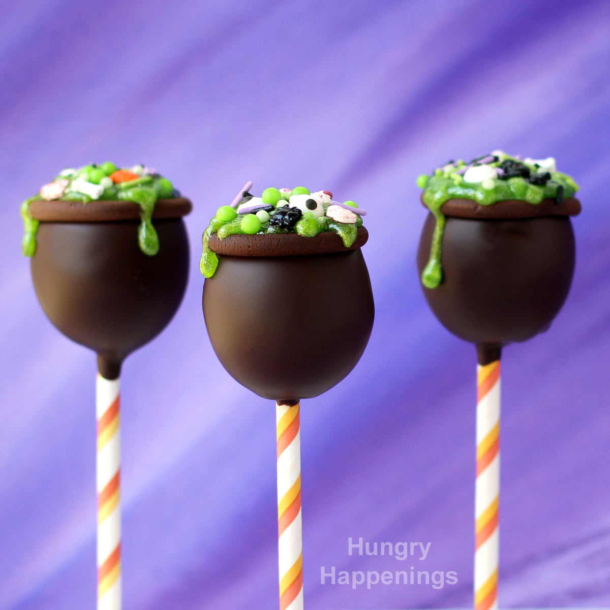 chocolate peanut butter cauldron pops topped with green slime gel and candy bones, eyes, and skulls.