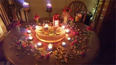 conversation heart cheesecakes on a Valentine's Day dinner table with candles and flowers. 