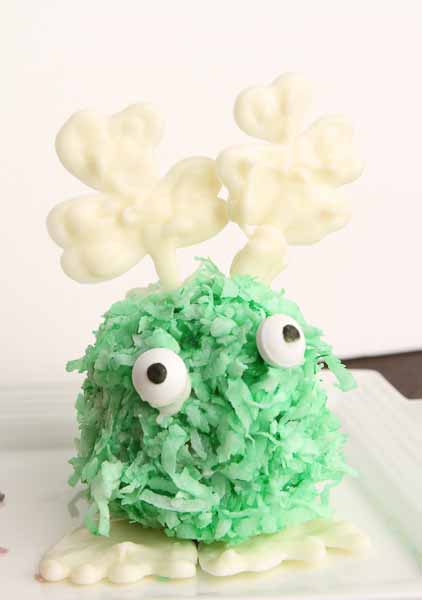 St. Patrick's day cake ball warm fuzzy with shamrock antennae. 