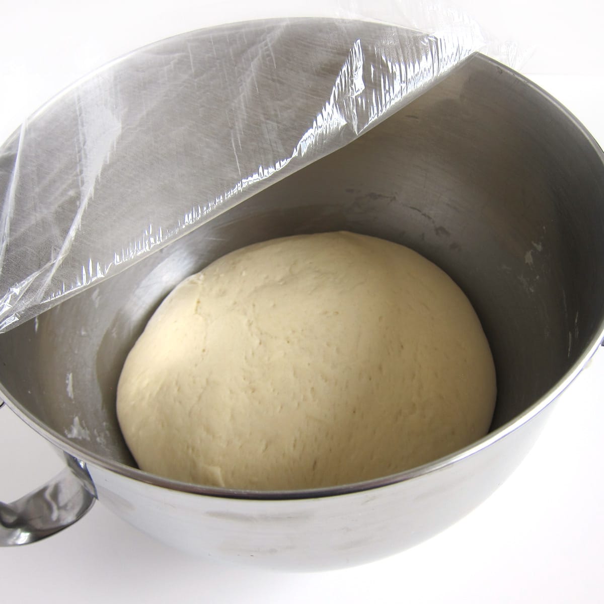 hamburger bun dough doubled in size in mixing bowl.