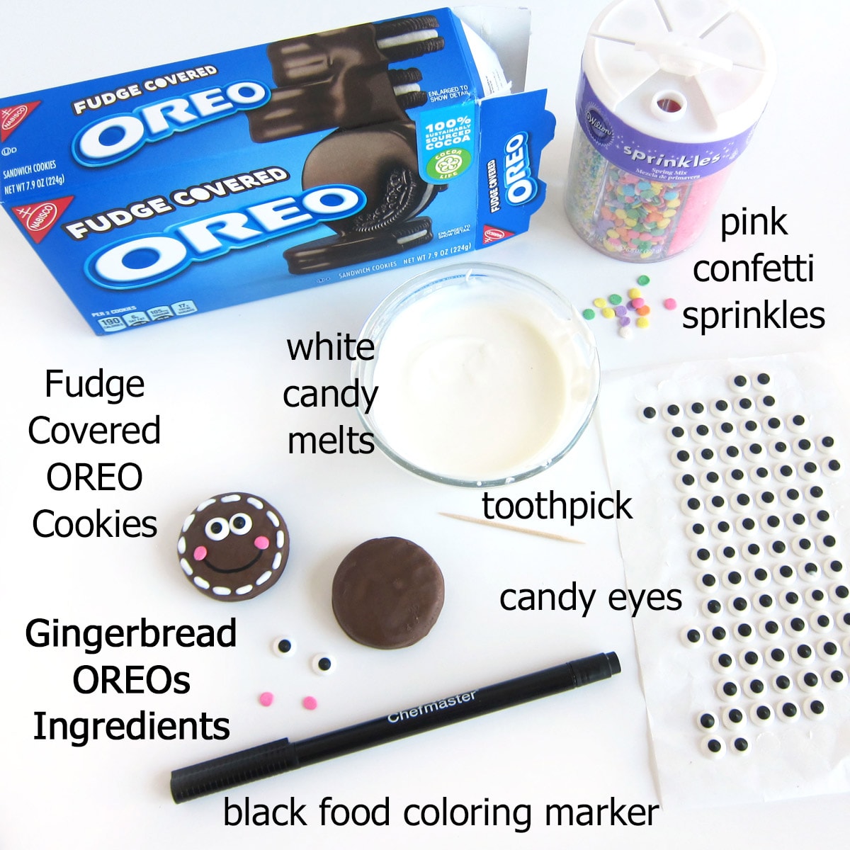 gingerbread OREOs ingredients including fudge covered OREO cookies, pink confetti sprinkles, white candy melts, candy eyes, and black food coloring marker. 