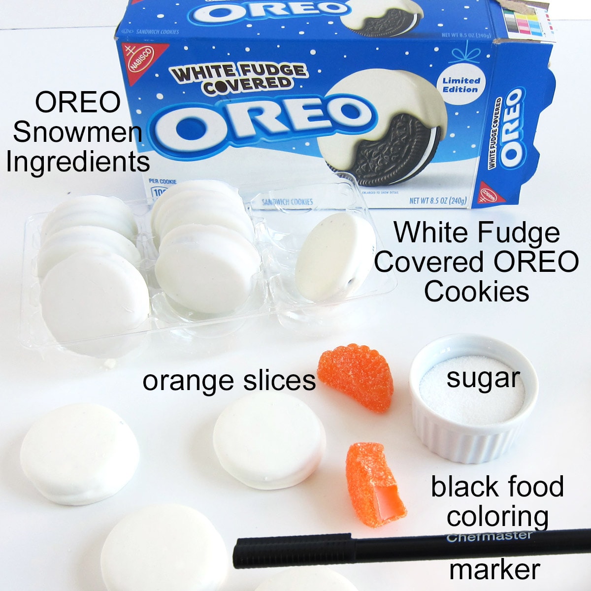 OREO Snowmen ingredients including white fudge covered OREOs, orange slices, and a black food coloring marker. 
