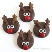 cute chocolate reindeer OREOs decorated with candy antlers, red M&M noses, and candy eyes.