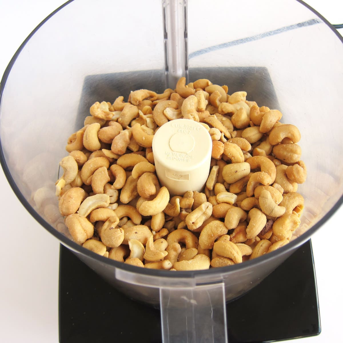 roasted and salted cashews in the bowl of a food processor.